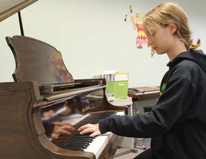 Teen playing piano